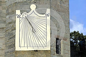 Old antique sundial attached to a medieval castle wall