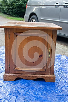 Old antique table set out on a blue tarp