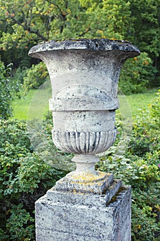 Old antique vase outside in green park, landscape view