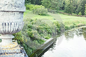 Old antique vase outside in green park, landscape view