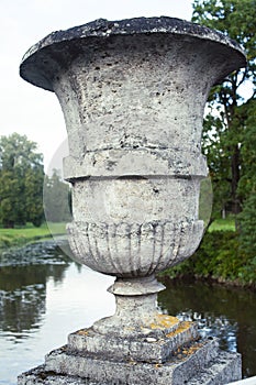 Old antique vase outside in green park, landscape view