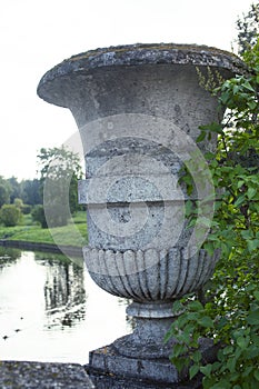 Old antique vase outside in green park, landscape view