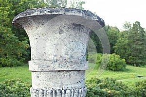 Old antique vase outside in green park, landscape view