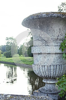 Old antique vase outside in green park, landscape view