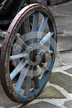 An old antique wagon wheel made of wood and metal