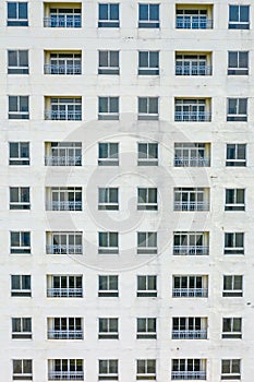 Old apartment building exterior with sloughing paint on the wall