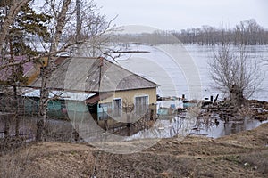 Old apartment building is flooded by waters of overflowing river. Natural disaster.