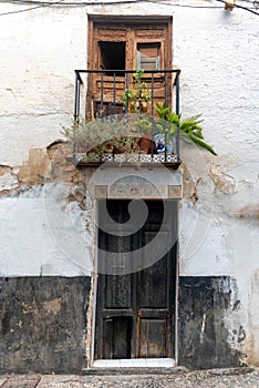 Old apartment building with small balcony in Granada, Spain