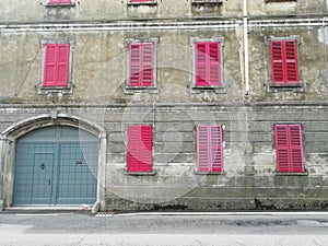 Old  apartments for sale   with pink shutters in Italy  Europe photo