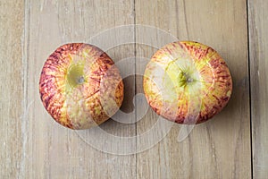 Old apple on wooden board