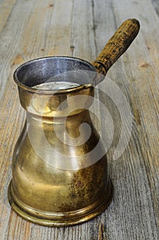 Old arabic coffee pot on wooden background