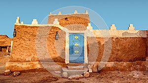Old Arabic House with Door and Antique Lanterns - Traditional Arab Mud Architecture - Part of an Old Fort Ã¢â¬â Home Made of Sand photo