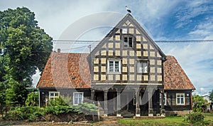 Old arcaded house with a half-timbered structure and stork on the roof photo