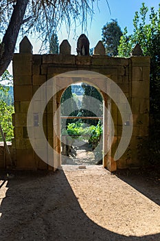 Old arch gate, path and staircase in granite to vineyards and typically Mediterranean, inside the gardens at the Solar de Mateus