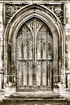 Old arched door in sepia tone