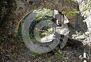 Old Arched wall of derelict Olive Mill/Press with millstone presses and workings