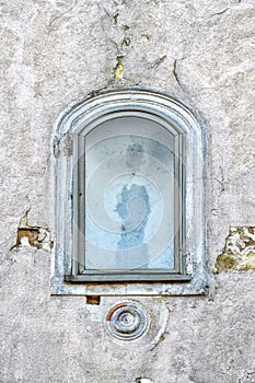 Old arched window on grunge concrete wall