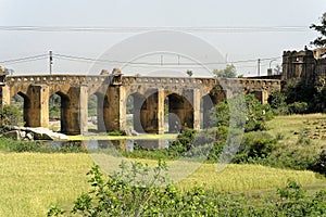 Old architectural bridge on the river Betwa at Orchha