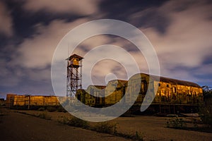 Old army watchtower in abandoned military base at night