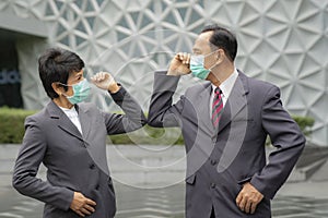 Old asian business people greeting togather by new methode with mask for prevent covid 19