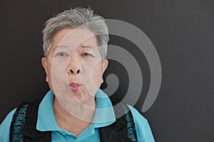 old asian elderly elder senior woman pucker up her lips