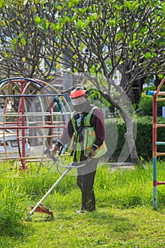 An old Asian gardener`s man post with lawnmowers before working in the garden