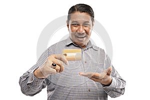 old asian man holding credit card showing it happily white background