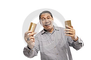old asian man standing while holding phone and card white background