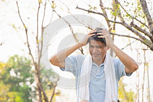 Old Asian people suffer from exercise pain. senior man suffering from headache