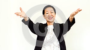 Old Asian senior woman wearing suit with happpy face and hand gestur