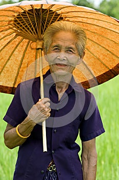 Old Asian woman with parasol