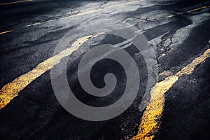 Old asphalt road cracks, splits, fracture and dividing line abstract background. Rough textured traffic transportation