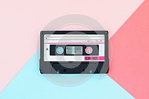 Old audio tape cassette on a multicolor background. Top view, old technology concept