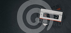 Old audio tape compact cassette on stone background