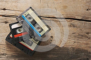 Old audio tape compact cassettes on wooden background