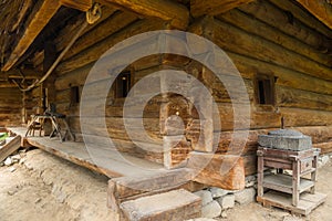 The old authentic Ukrainian hut, made of wooden beams with small windows in it