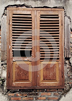 Old and Authentic Window on Rusty Broken and Ruined Wall with Scratch and Graffiti