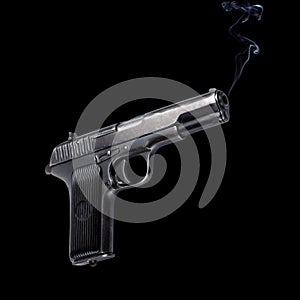 Old automatic pistol on black background