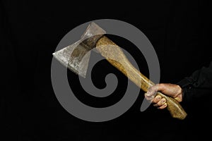 Old Axe in hand on a black background. Copy space