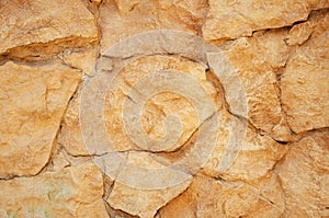 Old background orange stone wall close up