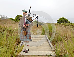 Old bagpiper, including his face photo