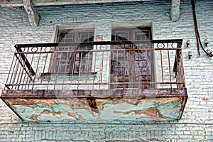 Old balcony on the green brick wall of the building photo