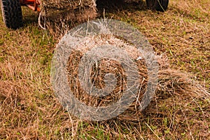 Old bale press, hay harvesting in the village for cattle, press work close up