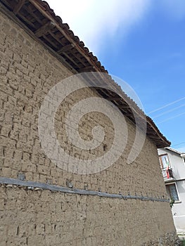 Old Balkan house clay wall. Vintage village clay bricks wall