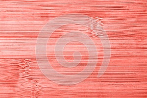 Old bamboo wooden texture background.Trendy living coral color of year 2019. Zero waste concept. Top view. Copy space