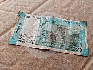 A old banknote of India with a denomination of 50 rupees. Indian currency. Portrait of Mahatma Gandhi