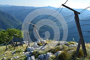 Old barb wired borderline on the mountain height