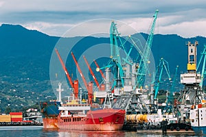 Old Barge Freight Ship Tanker And Heavy Loading Cranes Jib In Port