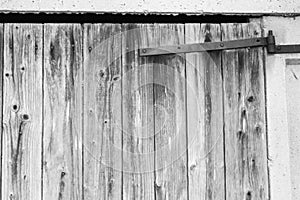 Old barn door with a rusty metal hinge