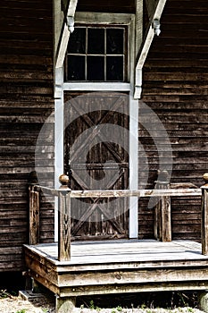 Old barn door with stoop and railing